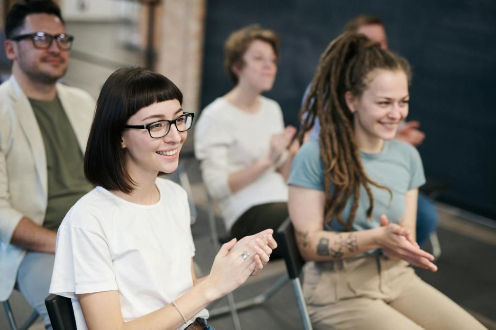 Young women in audience, clapping